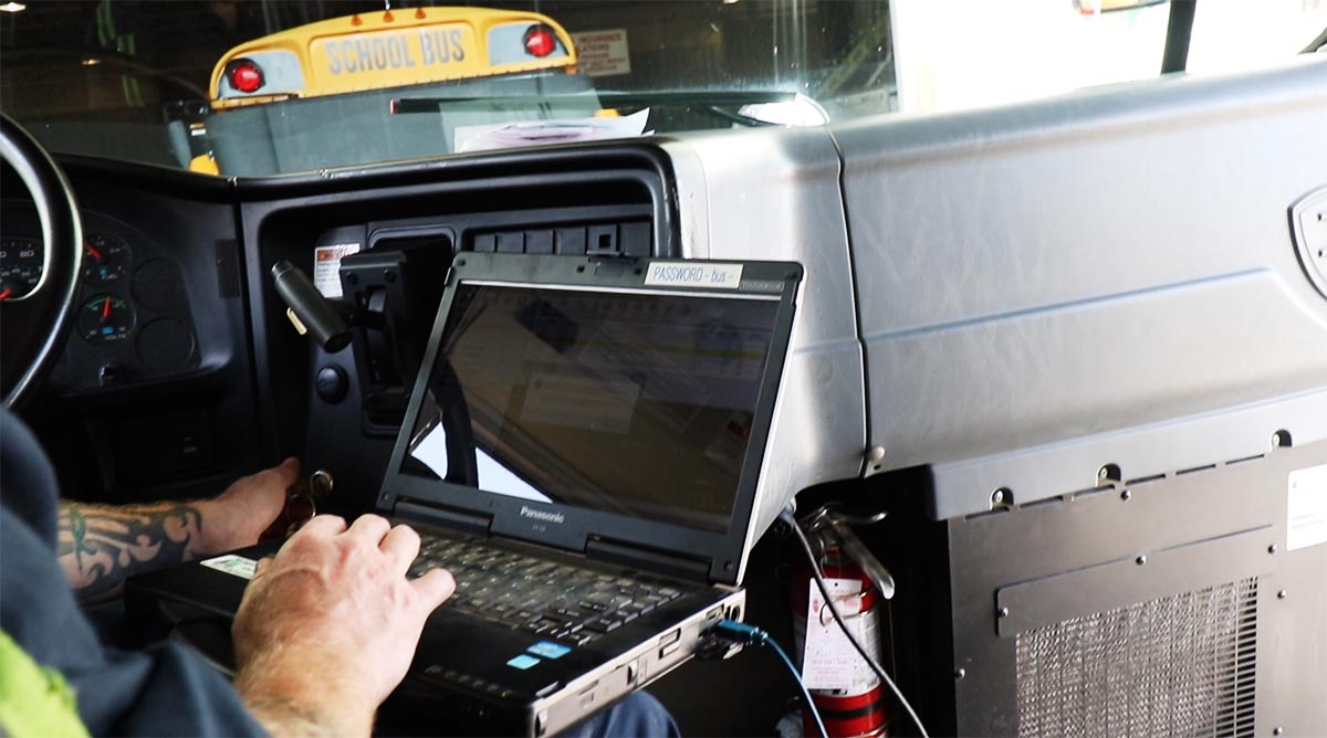 Bus mechanic diagnosing computer